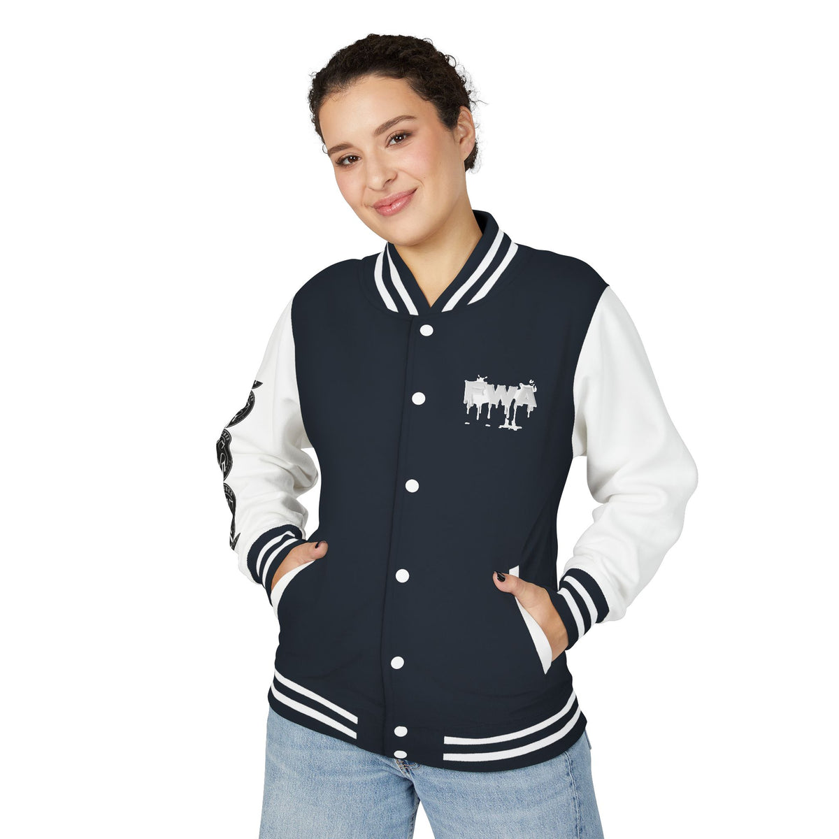 Front view of a woman wearing a black and white Faith In Motion Varsity Jacket with a paint-drip graphic.