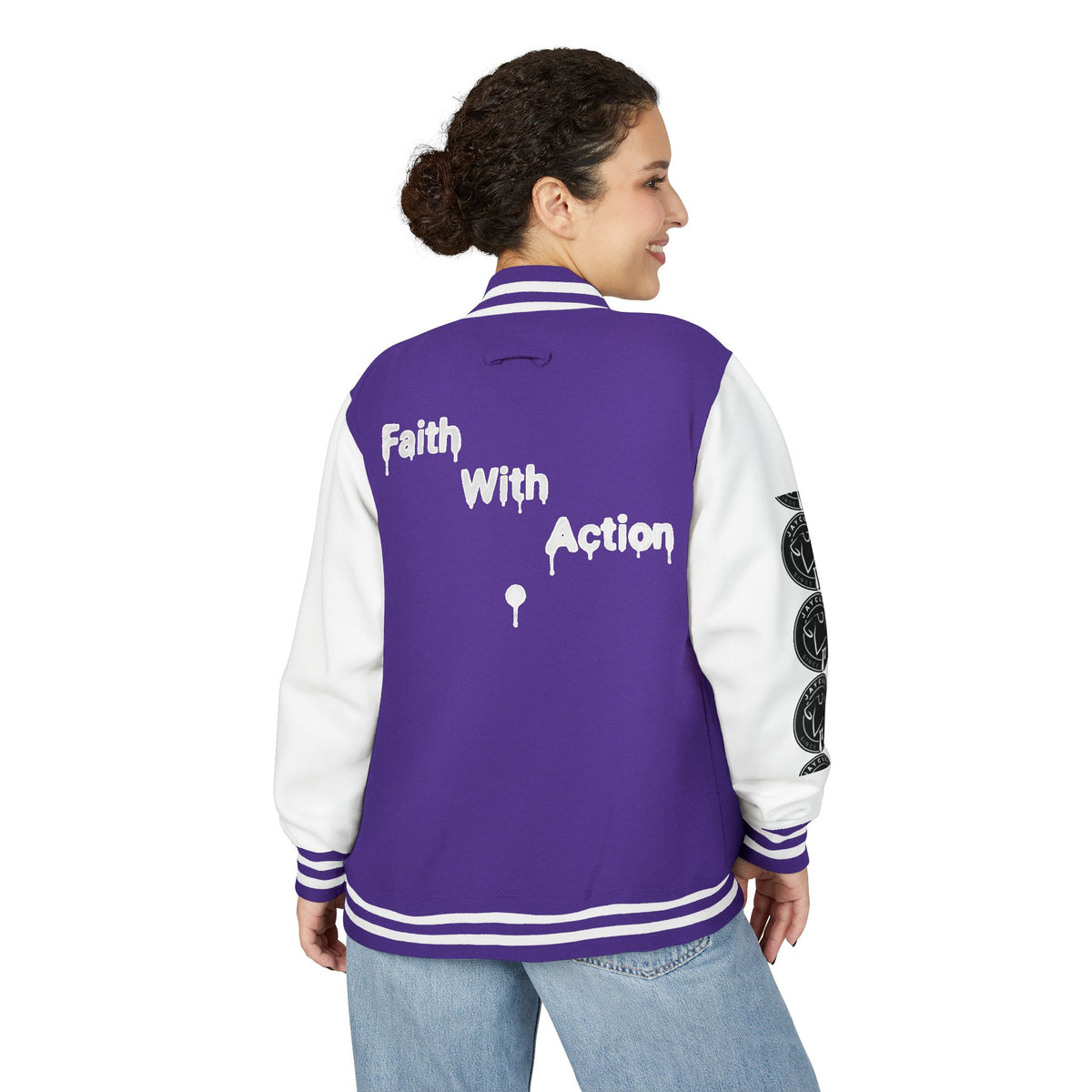Back view of a woman wearing a purple and white Faith In Motion Varsity Jacket with "Faith With Action" text.