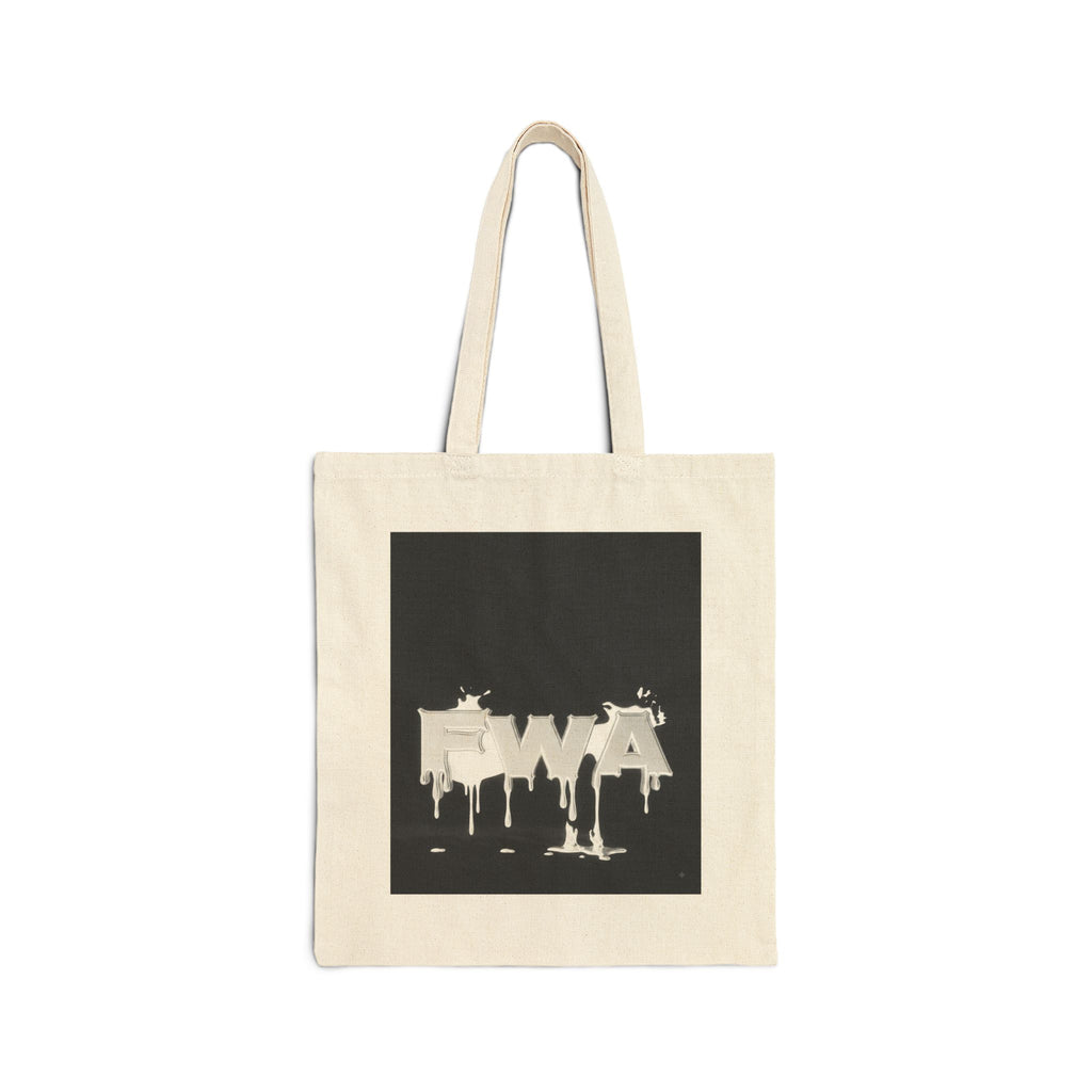 Front view of a natural canvas tote bag with a black square graphic featuring "EWA" in dripping white paint.