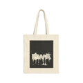 Front view of a natural canvas tote bag with a black square graphic featuring "EWA" in dripping white paint.