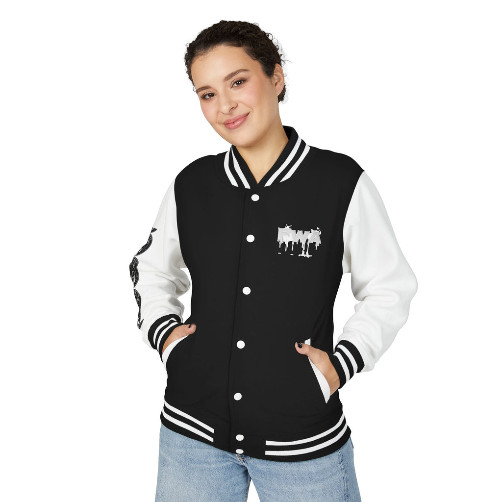 Front view of a woman wearing a black and white Faith In Motion Varsity Jacket with a dripping text graphic.