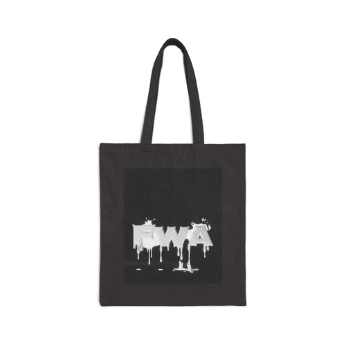 Front view of a black canvas tote bag with a white dripping paint design that spells 'EWA'.