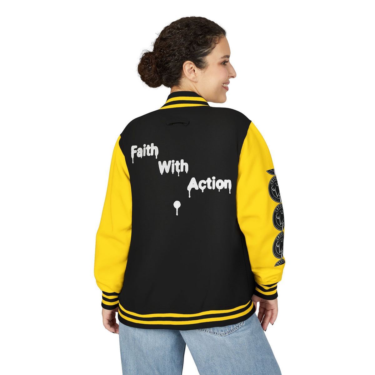 Back view of a woman wearing a black and yellow Faith In Motion Varsity Jacket with "Faith With Action" text.